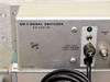 Close-up of SM-5 Signal Switcher front panel — label reads 'SM-5 SIGNAL SWITCHER 015-0281-00', PN 700-1928-01, fuse data plate showing 115V/0.8A SLO and 230V/0.4A SLO, green power indicator LED, and power toggle switch