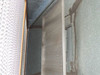 Interior of laminar flow hood plenum — showing perforated diffuser face and HEPA filter seating area with tape remnants