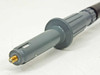 Close-up of Tektronix P6009 probe tip end showing gold-threaded screw contact and gray ribbed probe body