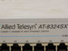 Allied Telesyn AT-8324SX front left close-up showing brand logo and 10 BASE-T / 100 BASE-TX Fast Ethernet Switch designation with ports 1X–6X and 13X–18X