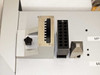 Close-up of BioRobot 8000 pipetting tool blocks — comb-style probe holder and 12-position multi-well probe block with star knob on deck surface