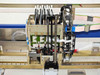 Close-up of BioRobot 8000 8-channel liquid handling pipetting head with servo motors, drive belt, probe array, and wiring harness