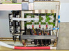 BioRobot 8000 internal electronics panel showing solenoid valve array, green backplane PCB, wiring harnesses, and red cylindrical drive component