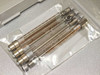 Close-up of five graduated glass syringe columns with metal end fittings in sealed plastic bag — included BioRobot 8000 accessories