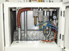 Lanco LTX08 upper interior compartment open — foil-insulated heat exchanger, brass pneumatic valves and fittings, blue pneumatic tubing, and pressure gauge