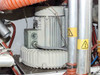 Second C.E.P. ring blower motor in Lanco LTX08 — gray finned housing with junction box, orange corrugated hose above, warning label on adjacent pipe