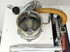 Lanco LTX08 stainless steel drying hopper open — interior stainless bowl visible with corrugated hose outlet, mesh filter port, and top-deck connectors