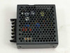 Nemic-Lambda EWS15-5 power supply bottom view showing perforated base, internal components visible through ventilation holes, and DIN rail mount bracket