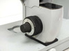 Coarse focus knob close-up — large calibrated dial with numbered scale, black knurled knob mounted on H-Stand column