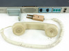 PADS Development Labs Series 10 Voice Terminal telephone handset with coiled cord and 4-pin connector adapter laid out below the unit