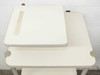 Top-down view of upper work surface with hook-and-loop strip and articulating arm base visible at upper left