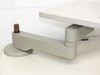 Close-up of articulating arm pivot joint and base mount with wooden knob tightening mechanism on work surface