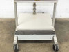 Lower cart view showing bottom shelf, anti-slip step strip, height adjustment locking clamps on column, and four caster wheels