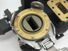 Varian VUJ-8527-01 – close-up of circular-to-rectangular waveguide transition showing brass flange face with rectangular aperture and O-ring groove, pivot assembly below