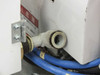 Sailor OE-2413 base — pneumatic fitting and blue air line connection at the base of the control enclosure