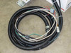 Sailor OE-2406 cable harness coiled on floor showing corrugated conduit and multiple bare wire ends with connector pigtails