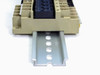 Underside of relay assembly showing metal DIN rail slider mounting rail and relay socket terminal connections