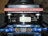 Kraus & Naimer A14 rotary switch detail — nameplate showing A14, Style-MC, UL listed markings, mounted between red brackets above blue terminal block