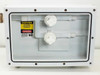 Fluoroware 201-35 chemical valves inside open sealed enclosure — front view showing both white quarter-turn valves, tubing connections, and caution/danger warning labels