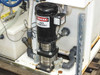 Baldor industrial motor close-up mounted to pump assembly on tank, with Danger Starts Automatically warning label