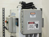 Electrical enclosure panel mounted to wall bracket with Danger High Voltage warning labels and power cord; GF Signet pH/ORP controller visible to left