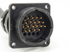 Close-up of multi-pin round trunk connector on Phoenix Contact SACB-8/16 showing gold male pin array and panel-mount flange
