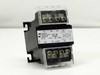 Hammond Manufacturing PT75QR 75VA control transformer — three-quarter front view showing primary terminal block (H1–H4) and secondary terminal block (X1–X4) with clear protective covers