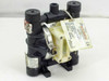 Wilden 00-5411-16 AODD pump front-left view showing black polypropylene body, stainless clamp bands, translucent air center section, and Wilden label tag