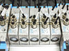 Close-up of MVH-5 D702 solenoid valve body row showing push-in pneumatic fittings, valve bodies, and D702 series markings