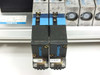 Two Festo JMVH-5 D702 solenoid valves side by side on manifold rail, showing blue valve bodies and 0.07 coil indicators