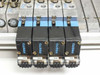 Row of four Festo JMVH-5 solenoid valves on manifold showing coil indicator windows labeled 0.15, 0.05, 0.03, and 0.07