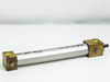 Pneumatic cylinder full right-side view showing aluminum barrel, brass end caps, and yellow port plugs on both ends