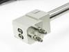 SMC CDRQB pneumatic linear rail end block closeup showing pneumatic port fittings and mounting face