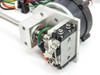 Side view of NSK YS2020FN001 motor assembly showing aluminum mounting bracket, actuator body, and pneumatic connections