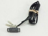 Unbranded magnetic proximity reed switch front view showing black rectangular housing with mounting bracket and bundled cable with spade connectors