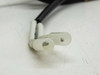 Close-up of spade terminal connectors at end of magnetic proximity sensor lead cable showing two white insulated female spade terminals