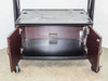Storage cabinet interior open, showing single shelf inside and cable port cutout on rear panel
