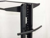 Close-up of vertical steel column showing height-adjustment holes and handle bracket for upper shelf