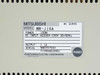 Mitsubishi MR-J10A rating label close-up — MODEL MR-J10A, 100W, AC INPUT 200-230V 50/60Hz, OUTPUT 1.1A, PASSED stamp, Made in Japan