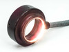Volpi fiber optic ring light cable — ring mount illuminated and glowing orange, demonstrating fiber optic light transmission through the ring