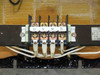 Secondary terminal block close-up showing u, v, w, E terminals with four white lead wires and partial rating plate visible