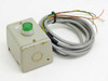 IDEC KGNW Control Box front view showing green pushbutton, empty second operator port, and pre-wired cable with surface wear on enclosure