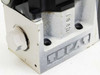 Tokimec hydraulic solenoid valve — bottom-side view of aluminum manifold base showing port openings and embossed logo