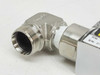 Close-up of opposite stainless steel 90° elbow fitting with Swagelok-style threads, part number label and S/N partially visible
