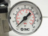 SMC analog pressure gauge closeup showing 0–160 PSI and 0–1.1 MPa dual scale, RoHS and NPT markings