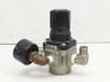 SMC AR30-N03-Z regulator showing gauge, elbow fittings, and body label — left-side rear view