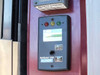 Alnor AirGard 335 airflow monitor with red, yellow, and green status LEDs, analog display, Emergency Purge button, and Test/Reset button mounted on fume hood column