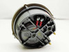 Dwyer 605-10 Magnehelic Transmitter rear housing view showing cast gray body, red and yellow wiring terminals, and brass pressure port fitting