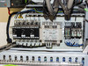 Controller enclosure electrical panel — circuit breakers (Fuji 7.5A), Omron S82K-05024 power supply, contactors