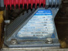 Close-up of Iwaki metering pump rating plate showing model EH-C20SH-200R9, capacity 130 mL/min, 0.69 MPa, 200V, 24W, 0.6A